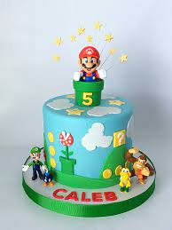 To make the ears and chin, cut the other two cupcakes in half. Super Mario Brothers Cake Mario Birthday Cake Mario Bros Cake Super Mario Birthday Party