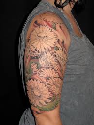 Half sleeve tattoo designs are a reflection of the person who wears them. Daisy Flowers Tattoos On Girl Right Half Sleeve