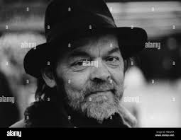 Homeless person with black hat at the subway station Marienplatz in Munich  Stock Photo