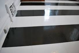 Black And White Stick On Floor Tiles Peel N Stick Tile In A Striped Pattern I Wish I Had Known About This Before Flooring Black And White Flooring Kitchen Makeover