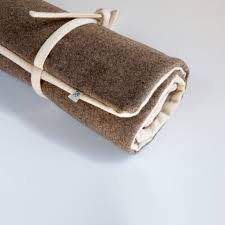 Rolled up dog beds, like mat pads, can be used indoors to line crates or on your bed for a place where the dog can sleep comfortably. Dog Travel Bed Natural Wool Roll Up Bed