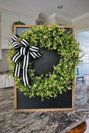 Black And White Striped Ribbon Wreath Featuring A Farmhouse Inspired Wreath Arrangement Decorated Realistic Looking Green Eucalyptus Mixed With Beach Basswood Stems Green Wreath Wreaths Grape Vines