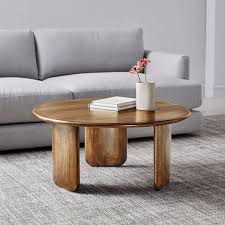 For a natural take, opt for wood, or go with brass, chrome or gold to bring some shine to the space. Anton Solid Wood Coffee Table Round