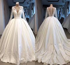 Find the wedding dress of your dreams at a store near you. Modest Long Illusion Sleeves Ball Gown Wedding Dresses Plunging V Neck Covered Buttons Back Satin Lace Applique Sweep Train Wedding Gowns From Suelee Dress 142 58 Dhgate Com
