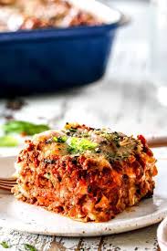 A Slice Of Traditional Lasagna With Layers Of Ricotta Noodles Meat Sauce Mozzarella Parmesan With Fresh Best Lasagna Recipe Lasagna Recipe Homemade Lasagna