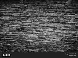 Most often, stone wall cladding is seen in homes with a rustic style as they seem the perfect match for them. Black Stone Wall Image Photo Free Trial Bigstock