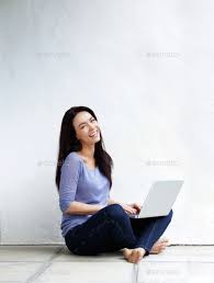 Happy Young Woman Sitting On Floor At Home With A Laptop By Mimagephotography Portrait Of Happy Young Woman Sitting On Floor At Technology Photos Women Young