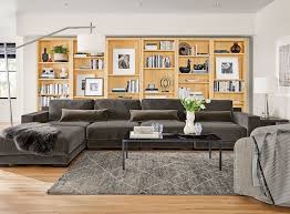 Earthy living room elegant living room new living room my new room home and living living room ideas with grey couch gray living room walls living room wall art modern living rooms. White Walls Wooden Floor Large Wooden Bookshelves Dark Grey Couch Da Ottoman In Living Room Modern Furniture Living Room Contemporary Living Room Furniture