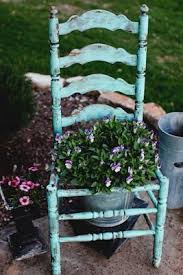 Not Crazy About The Flower Pot But I Like The Chair For The Distressed Look And Shape Gardenchair Chair Planter Garden Chairs Wooden Garden Chairs