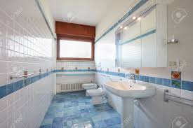 White or blue linens pick up colors used in the mosaic without looking abrasive (as orange might). Normal Bathroom With Blue And White Tiles In Apartment Interior Stock Photo Picture And Royalty Free Image Image 117877238