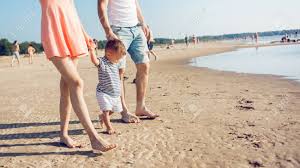 But, for safety reasons, babies should begin wearing shoes on their feet with a hard enough sole to protect their feet from injuries when they are learning to walk outside. Mom And Dad Teach Baby To Walk Young Happy Family Walking On Stock Photo Picture And Royalty Free Image Image 113990698