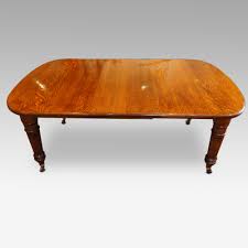 Vintage oak extending farmhouse draw leaf kitchen dining table, the twin pedestal base has painted black the table simply extends to seat six people the table base has been sanded down, primed twice with dulux undercoat top coated in black the table top and the extending sections have been sanded Victorian Oak Extending Dining Table Hingstons Antiques Dealers