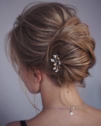 It is created by gathering the hair in one hand and twisting the hair upwards until it turns in on itself against the head. This French Twist Updo Hairstyle Perfect For Any Wedding Venue