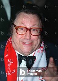 Image of Belgian comedian Raymond Devos smiles as he attends the awards