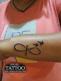 It can be inked on hands, at the back or side of the neck, and even on the ankle. Infinity With Birds And Word Free Tattoo Rose Tattoo On Arm Free Tattoo Angel Tattoo Designs