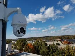 A Ptz Pan Tilt Zoom Camera High Atop Camera Security Now Headquarters Ptz Camera Security Camera Camera