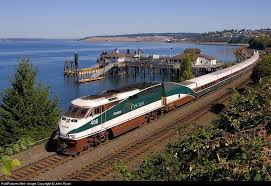 Få 19.000 sekund stockvideoklipp på bike ride on boat ferry med 29.97 fps. Classic Puget Sound A Southbound Cascade Dashes Past The Ferry Dock In Steilacoom The Tacoma Narrows Bridge Is Visible In Amtrak Tacoma Narrows Bridge Train
