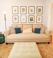 Large oversized clock as a centered anchor piece; Design Dilemma What To Hang On The Big Wall Behind Your Sofa Emily A Clark Home Living Room Living Room Inspiration Home Decor