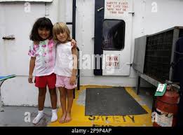 Kiah Dean, 5, left, and her cousin Shelby Foret stand together