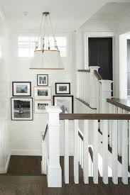 Black And White Gallery Wall Stairs Cottage Shiplap Staircase Surrounds Shiplap Walls Showcasing A Black And White Photo Gallery Under A Small Win Painted Staircases Staircase Design House Design