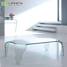 Clear glass dining table with three cylindrical bases. China Modern Style Wavy Clear Bent Glass Magazine Table China Glass Furniture Tables