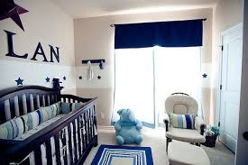 Boy Nursery With Beige And White Walls With Star Motifs Dark Brown Crib Dark Navy Details P Baby Boy Room Decor Elephant Baby Rooms Baby Boy Nursery Decor