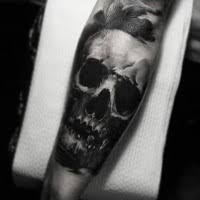 Where to put a black arm band tattoo? Simple Black Ink Forearm Tattoo Of Human Skull Tattooimages Biz