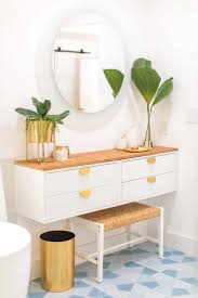 Beautiful bathroom with shiplap clad half walls finished with patterned gray wallpaper above framing a small dressing room with transom window over the door featuring a striped skirted dressing table with paneled mirror above and a white vanity chair in front over neutral tiled floors. Diy Dressing Table How To Make An Ikea Vanity Hack Sugar Cloth