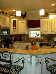 French country pottery can be the inspiration for the room. Black Glazed Ivory Cabinets Traditional French Country Red Black Ivory Cream Island Lighting Barstools Roo French Country Kitchens Kitchen Remodel Kitchen Redo
