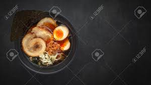 It is one of my favorites. Top View Asian Ramen Noodle Soup With Chashu Japanese Braised Pork Belly Nitamago Egg Sliced Spring Onion Ajitsuke Menma And Dried Seaweed On Dark Texture Background With Copy Space For Text Stock