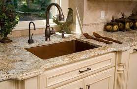 Cabinets are a cherry wood, appliances are stainless steel, floor is an off white/cream tiling, countertop is a beige/grey/black granite. 7 Golden Beach Granite Ideas Granite Kitchen Kitchen Remodel Kitchen Design