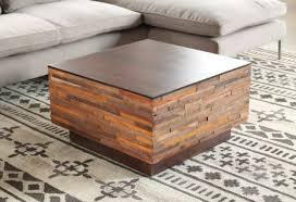 This coffee table leans into its coastal farmhouse look with natural wood finishes and a mixed material design. Recycled Wood Block Square Coffee Table To Rent As Prop