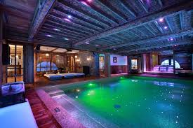 We Love How The Lighting Tile And Color Choices Make This Swimmingpool Look Extraordinary D Luxury Swimming Pools Indoor Swimming Pools Luxury Ski Holidays
