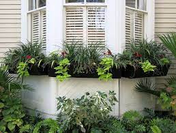 Tile out your front garden in different sized slabs to make it look bigger and line the edges with solar they allow lots of light through the window and won't require replanting next year if the drainage is 27. Bay Window With Window Boxes Charleston Sc Window Garden Ideas Bay Window Garden Fall Window Boxes