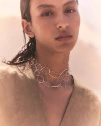 Dye, asymmetric top made from maltinto stretch silk silk and paired with  the high-waisted Mite pants which are worn crossed at the front with an  integrated belt of the same fabric that