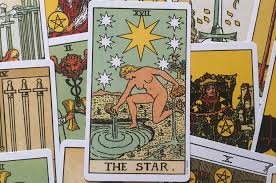 The star card shows a woman kneeling at the edge of a small pond. The Star Tarot Card Meanings In The Tarot Deck