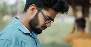 Bearded Man in Blue Top Using a Cellphone · Free Stock Photo