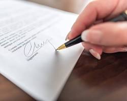 Image of person signing a contract