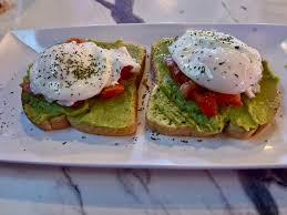 Avocado toast with poached egg and tomatoes