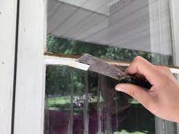 Hanging decorations using rope caulking windows before painting. Learn How To Paint A Window Exterior How Tos Diy
