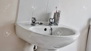 two faucets near toothbrush. stock