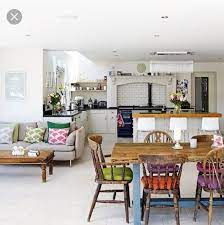 With a little imagination, your dining room could just as well be a warm. Mismatched Wood Chairs At A Big Farmhouse Table Like The Removable Cushions Open Plan Kitchen Living Room Kitchen Dining Living Open Plan Kitchen Diner