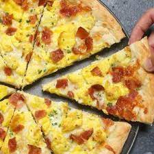 Easy Breakfast Pizza Recipe Begins With Homemade Pizza Dough Topped With Crisp Bacon Bits Scrambled Breakfast Pizza Recipe Breakfast Pizza Homemade Breakfast
