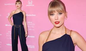 Taylor swift enjoys her time at the beach as she looks amazing in that blue swimsuit and pink hat. Taylor Swift Stuns In Navy Jumpsuit As She Is Leads Stars On Red Carpet At Billboard Women In Music Daily Mail Online