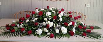 Please share your thoughts on this article. Red And White Casket Flowers