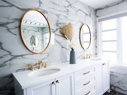 The brass mirror really stands out against the gray wallpaper while the two brown nickel and glass wall sconces tie it all together. Modern Bathroom Designs From Mecca Interior Designers
