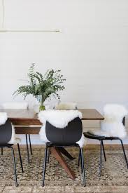 Vintage Area Rug Under The Dining Table Wood Dining Table Paired With Black Chairs Sheepskin Fur T Wood Dining Table Black Dining Chairs Dining Room Chairs
