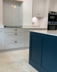 Mark poprawski painting 'one too grey bespoke kitchen, cornforth white and plummet paint, cox and cox wooden stools, honey oak van goth flooring. Portree Cornforth White Hague Blue Oak What A