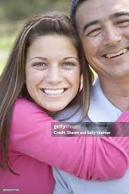 Teenage Girl Hugging Father Smiling Portrait High-Res Stock Photo