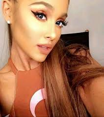 Ariana has her signature style that is a high sleek pony with winged liner complimenting her eyes. Ariana Grande